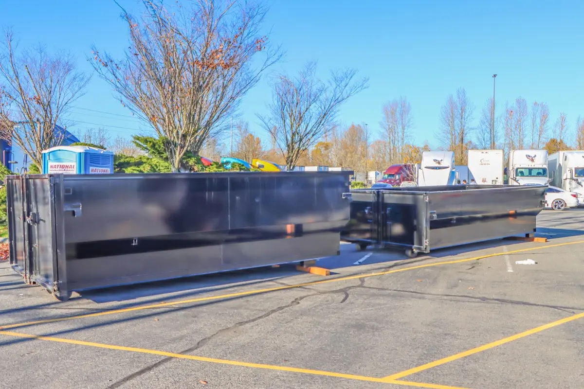 Professional dumpster rental service with roll-off container on residential driveway in Summerfield